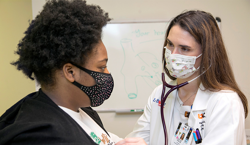 Dr. Ryan listens to the heart of a patient in the hypertrophic cardiomyopathy clinic.